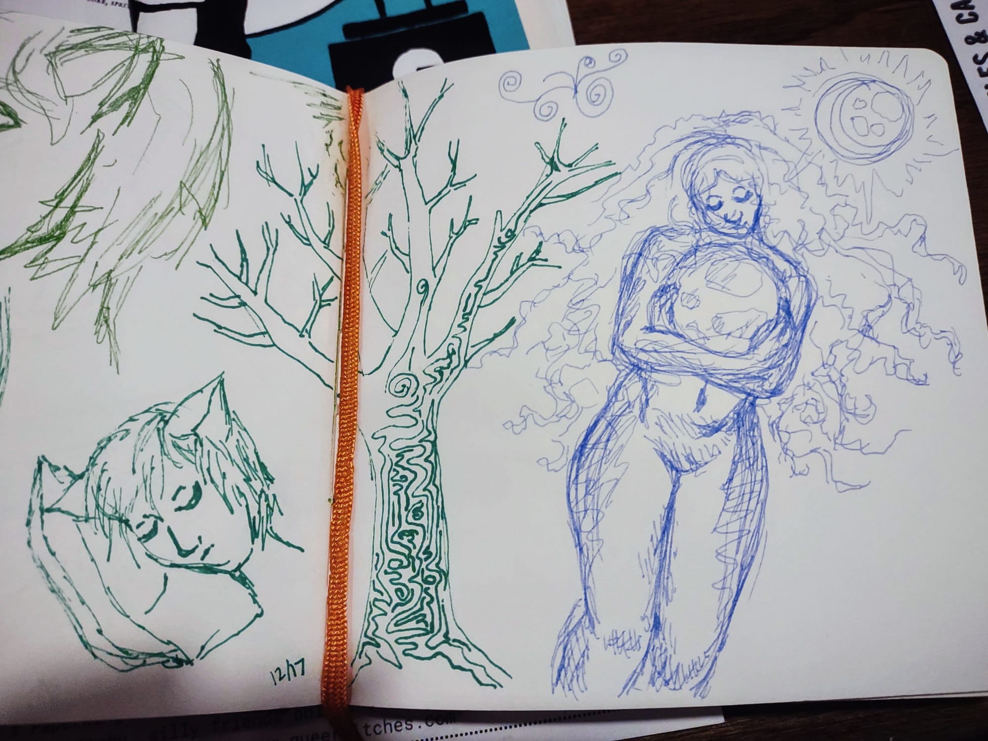 Sketchbook open to two pages of pen drawings, with only part of the left page shown. Left page: head and neck of a short-haired person with cat ears sleeping on a pillow. Right: a leafless tree with a squiggly pattern over the trunk, and then, a nude woman with long curly hair cradling a moon in her arms.